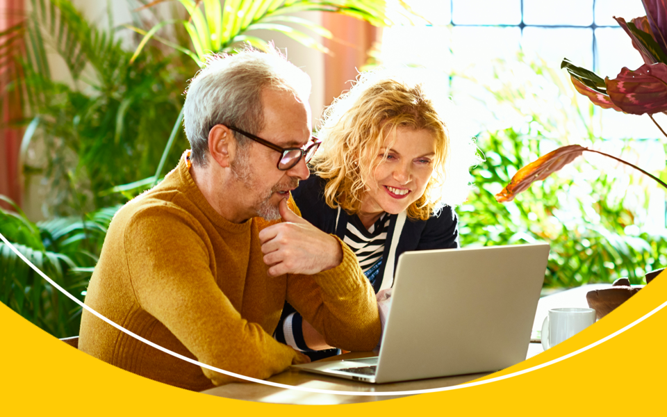 Man and a woman viewing a laptop screen together