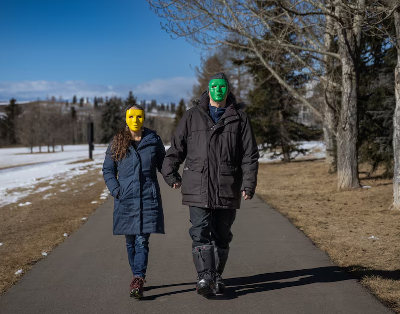 a faceless couple. Couple wearing masks for a walk in the winter.