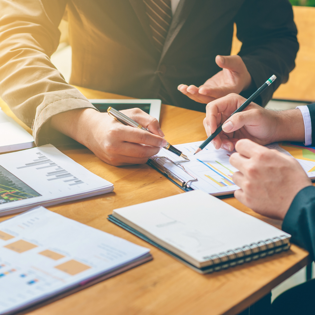 Cropped shot of hands reviewing financial documents in a financial planning meeting