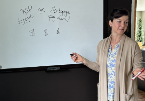 Female advisor leading a meeting at a whiteboard in an office.