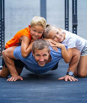 Happy family exercising together in gym