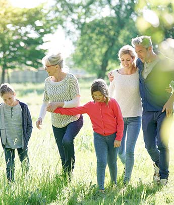 happy family of 6 walking through the park