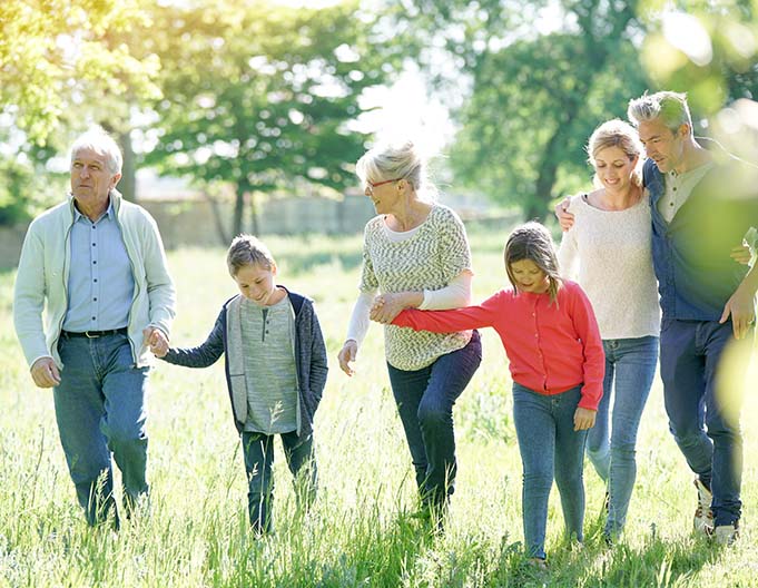 happy family of 6 walking through the park