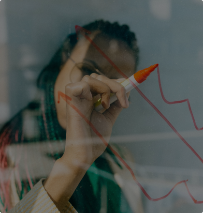 A women drawing on a pane of glass