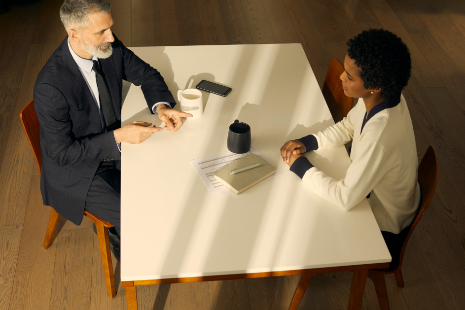 Two people meeting at a table.