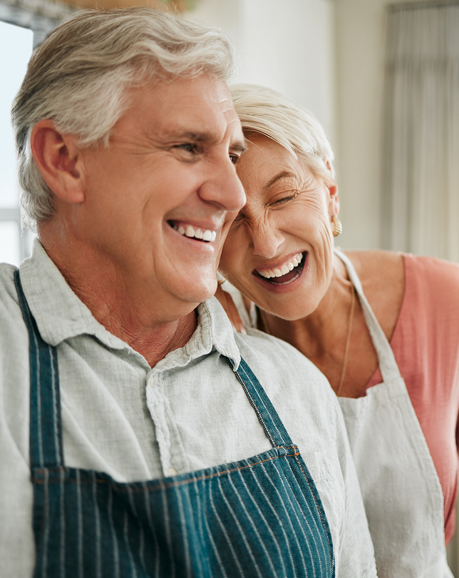 Retired couple smiling while planning their financial future